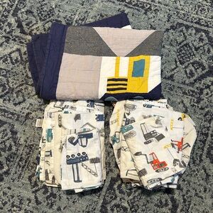 Pottery barn toddler quilt and two sets of sheets with pillowcases.